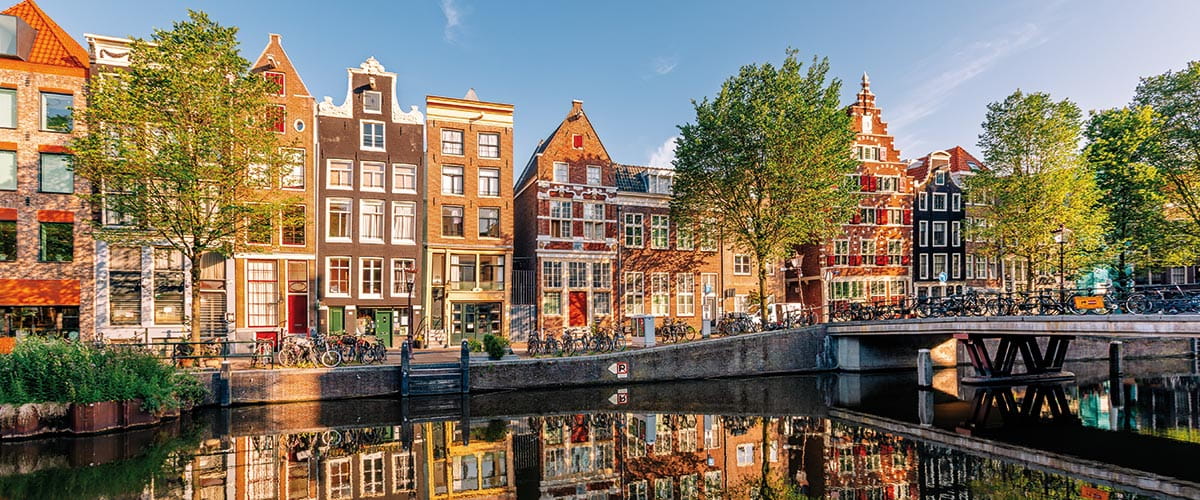 Traditional Dutch houses by a canal in Amsterdam